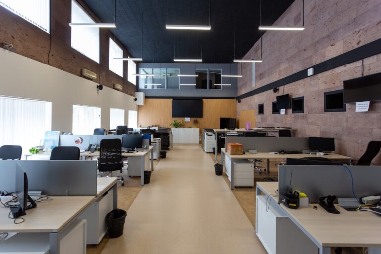 Open-plan office with desks and ceiling lights illustrating office WiFi coverage planning