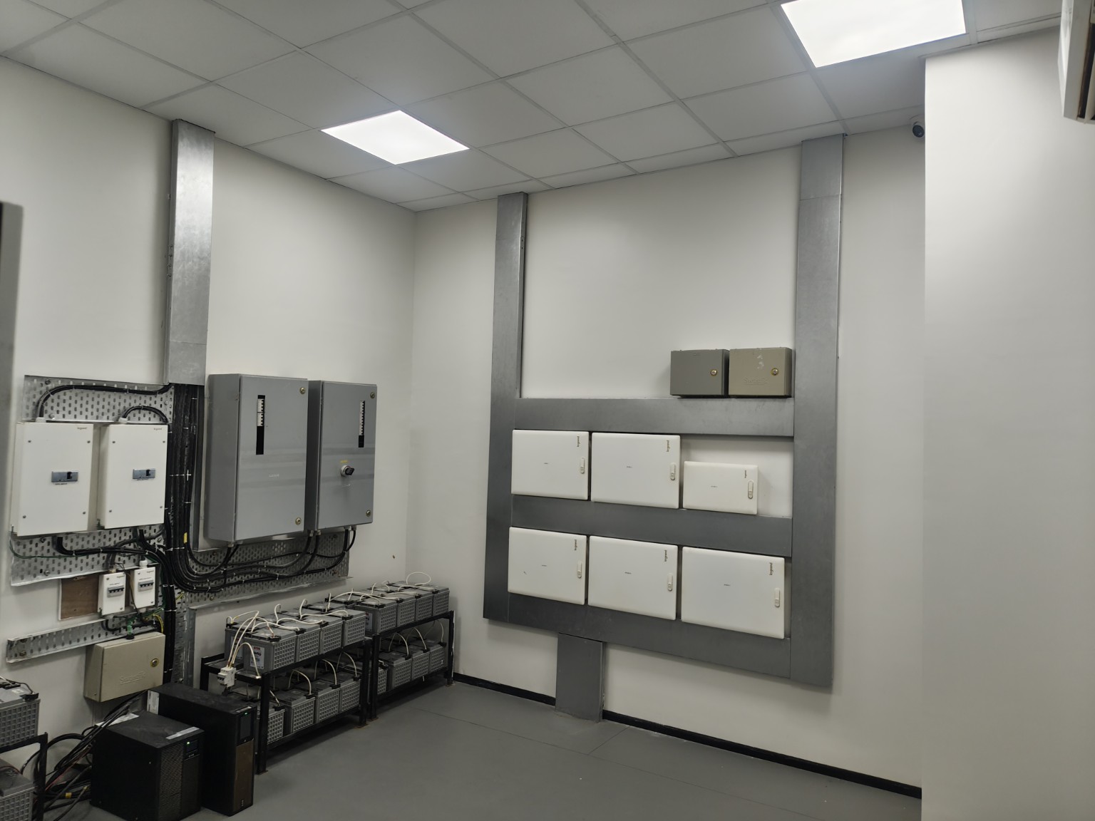 Electrical room with distribution boards and battery banks at Group Surya, Indapur